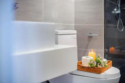 a bathroom with a toilet with a candle on it at Trion Residence KL near TRX, MyTown, Ikea Cheras, Pudu in Kuala Lumpur