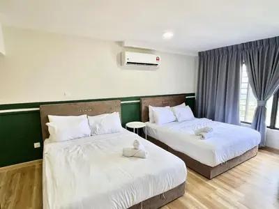 a bedroom with two beds with white sheets at Arte Cheras Kuala Lumpur in Kuala Lumpur