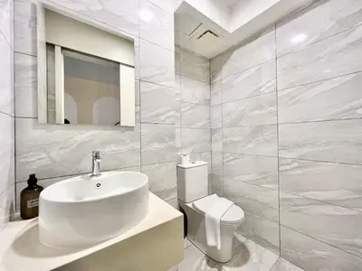 a white bathroom with a sink and a toilet at Arte Cheras Kuala Lumpur in Kuala Lumpur