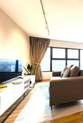 a living room with a couch and a tv at Arte Cheras Kuala Lumpur in Kuala Lumpur