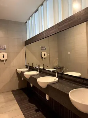 a public bathroom with four sinks and a mirror at The Robertson KLCC 1 room 1 bathroom by JZ in Kuala Lumpur