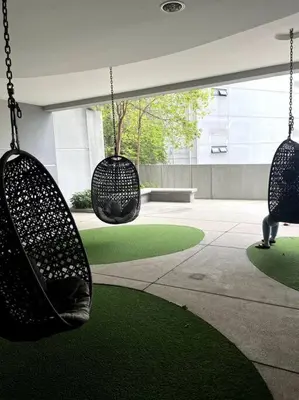 a room with two hanging chairs in a building at The Robertson KLCC 1 room 1 bathroom by JZ in Kuala Lumpur