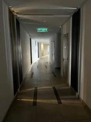 a hallway of a building with a sign that reads lungs at The Robertson KLCC 1 room 1 bathroom by JZ in Kuala Lumpur