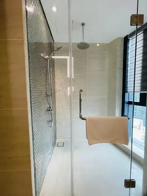 a bathroom with a shower with a glass door at Star Resident KLCC By M&T in Kuala Lumpur