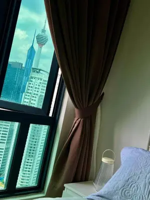 a bedroom with a window with a view of the city at Legasi High floor 3 BR KLCC view in Kuala Lumpur