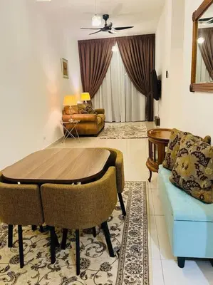 a living room with a table and a couch at Legasi High floor 3 BR KLCC view in Kuala Lumpur