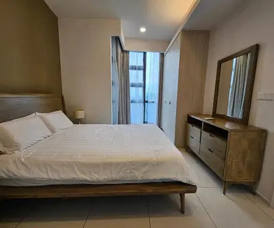 a bedroom with a bed and a dresser and a mirror at Apartment at Robertson by Wgshomestay in Kuala Lumpur