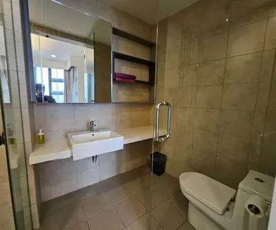 a bathroom with a sink and a toilet and a mirror at Apartment at Robertson by Wgshomestay in Kuala Lumpur