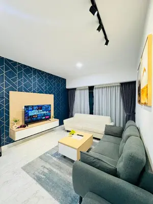 a living room with a couch and a tv at Eaton Service Apartment at KLCC in Kuala Lumpur