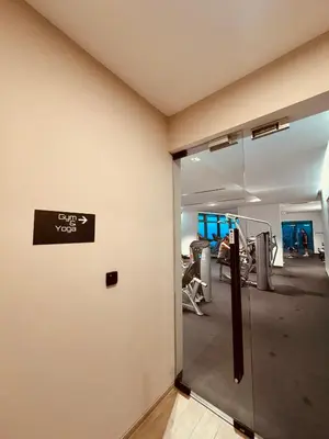 a room with a gym with a glass door at Eaton Service Apartment at KLCC in Kuala Lumpur