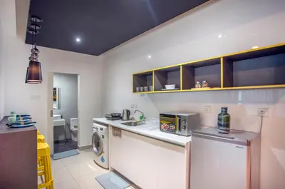 a kitchen with a refrigerator and a washer and dryer at Arte Plus Ampang Free Parking in Kuala Lumpur