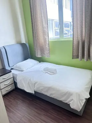 a small bedroom with a bed and a window at Ubays Zetepark House in Kuala Lumpur