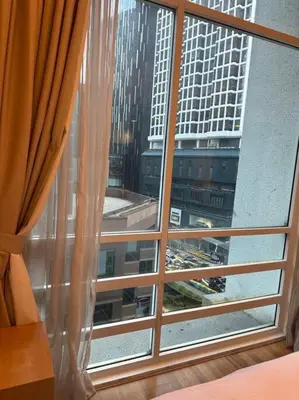 a large window with a view of a city at Luxzell suit KlCC-7minutes walk to KLCC in Kuala Lumpur