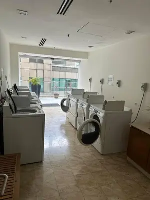 a laundry room with three washing machines in it at Luxzell suit KlCC-7minutes walk to KLCC in Kuala Lumpur