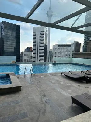 a swimming pool on top of a building with a city at Luxzell suit KlCC-7minutes walk to KLCC in Kuala Lumpur