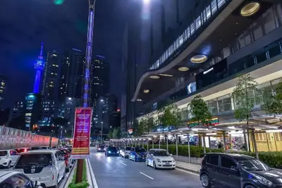 a city street at night with cars parked at The Royal Reside in Kuala Lumpur