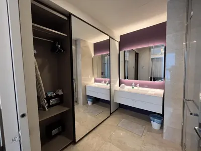 a bathroom with two sinks and two mirrors at Tropicana The Residences by uBook in Kuala Lumpur