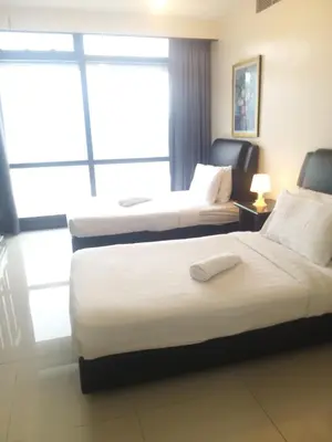 a hotel room with two beds and a window at 1 Imbi Suites Times Square Bukit Bintang KL in Kuala Lumpur