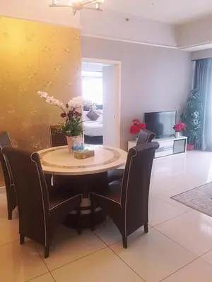 a living room with a table and chairs and a tv at 1 Imbi Suites Times Square Bukit Bintang KL in Kuala Lumpur