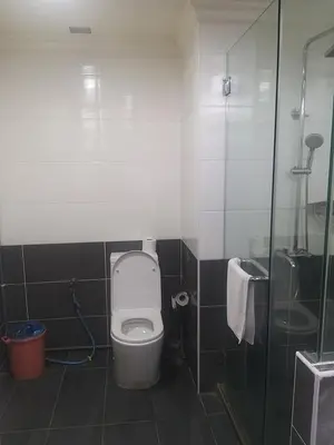 a bathroom with a toilet and a shower at 1 Imbi Suites Times Square Bukit Bintang KL in Kuala Lumpur