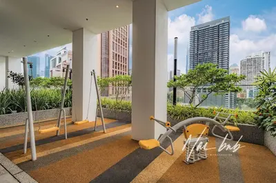 a gym in a building with a view of the city at NaiBnB in Quill Residences in Kuala Lumpur
