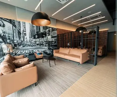 a living room with two couches and a painting of a city at Neu suites cozy 2 bedrooms family house in Kuala Lumpur