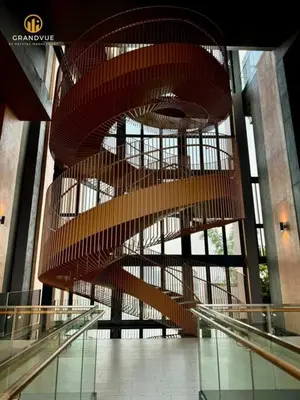 a large spiral staircase in a building withwindows at Lucentia BukitBintang KlccView InfinityPool By HeyStay Management in Kuala Lumpur