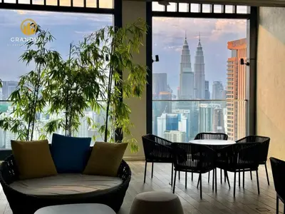 a room with a table and chairs and a view of the city at Lucentia BukitBintang KlccView InfinityPool By HeyStay Management in Kuala Lumpur
