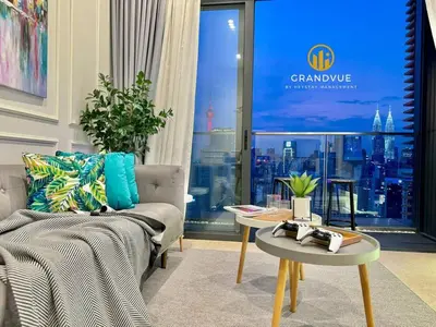 a living room with a couch and a table at Lucentia BukitBintang KlccView InfinityPool By HeyStay Management in Kuala Lumpur