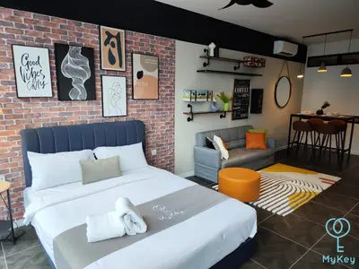 a bedroom with a large bed and a brick wall at Scarletz Starlight Suites KLCC in Kuala Lumpur