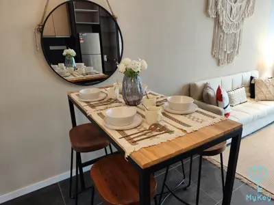 a dining room table with a mirror and a couch at Scarletz Starlight Suites KLCC in Kuala Lumpur