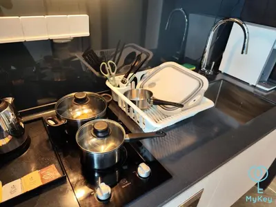 a kitchen counter with two pots and pans on a stove at Scarletz Starlight Suites KLCC in Kuala Lumpur