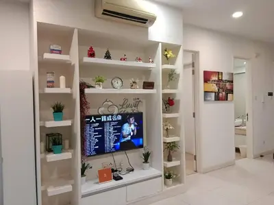 a living room with a tv on a wall at Cozy Suite to NEXUS n LifeCare Med in Kuala Lumpur