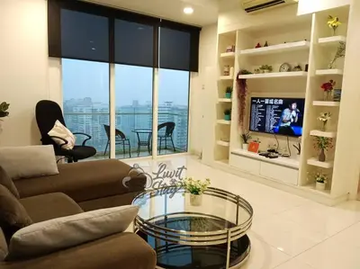 a living room with a couch and a glass table at Cozy Suite to NEXUS n LifeCare Med in Kuala Lumpur
