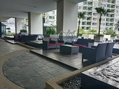 a lobby with chairs and tables in a building at Cozy Suite to NEXUS n LifeCare Med in Kuala Lumpur