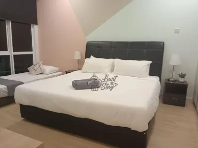 a bedroom with a large bed with a bag on it at Cozy Suite to NEXUS n LifeCare Med in Kuala Lumpur