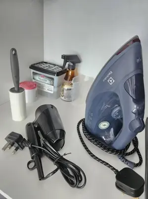 a desk with a hair dryer and a phone on it at Luxury Spacious 4 Bedroom Suite - Cheras Maluri MRT in Kuala Lumpur