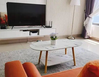 a living room with a coffee table and a flat screen tv at Luxury Spacious 4 Bedroom Suite - Cheras Maluri MRT in Kuala Lumpur