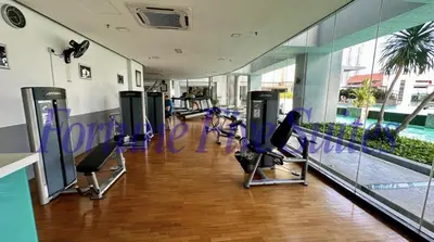 a gym with a row of exercise equipment in a building at SG Residence Kuala Lumpur by Fortune Suites in Kuala Lumpur