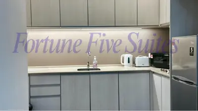 a kitchen with the words fortune five shuttle on the wall at SG Residence Kuala Lumpur by Fortune Suites in Kuala Lumpur