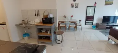 a kitchen and living room with a table and chairs at Robertson Bukit Bintang in Kuala Lumpur
