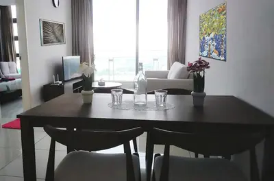 a dining room table with chairs and a bottle and glasses at Robertson Bukit Bintang in Kuala Lumpur