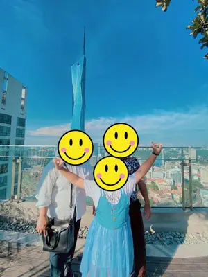 a man and a woman holding up smileys on their heads at Robertson Bukit Bintang in Kuala Lumpur