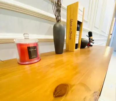 a candle and a vase on a wooden table at Trion KL Premium Suite in Kuala Lumpur