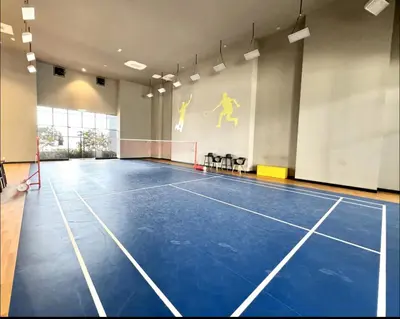 an indoor tennis court with a net in a gym at Trion KL Premium Suite in Kuala Lumpur