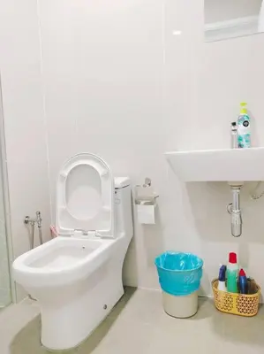 a white bathroom with a toilet and a sink at Charming Haven in Kuala Lumpur 100Mb TRX Mall in Kuala Lumpur