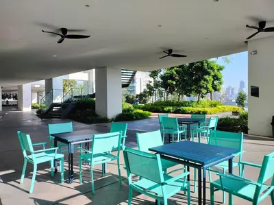 a group of blue tables and chairs on a patio at Charming Haven in Kuala Lumpur 100Mb TRX Mall in Kuala Lumpur