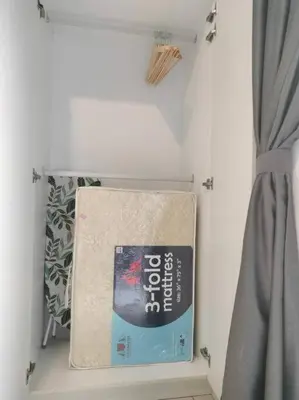a book hanging on a wall next to a curtain at Charming Stay in the Heart of Kuala Lumpur 100Mb in Kuala Lumpur