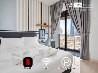 a bedroom with a white bed with a desk and a window at Sleek 3BR Suites Near TRX By Rumabnb in Kuala Lumpur