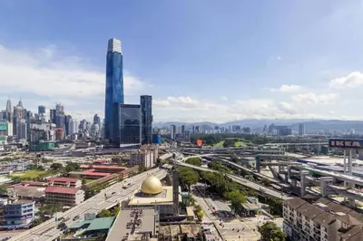 a city with tall buildings and a street with cars at Sleek 3BR Suites Near TRX By Rumabnb in Kuala Lumpur